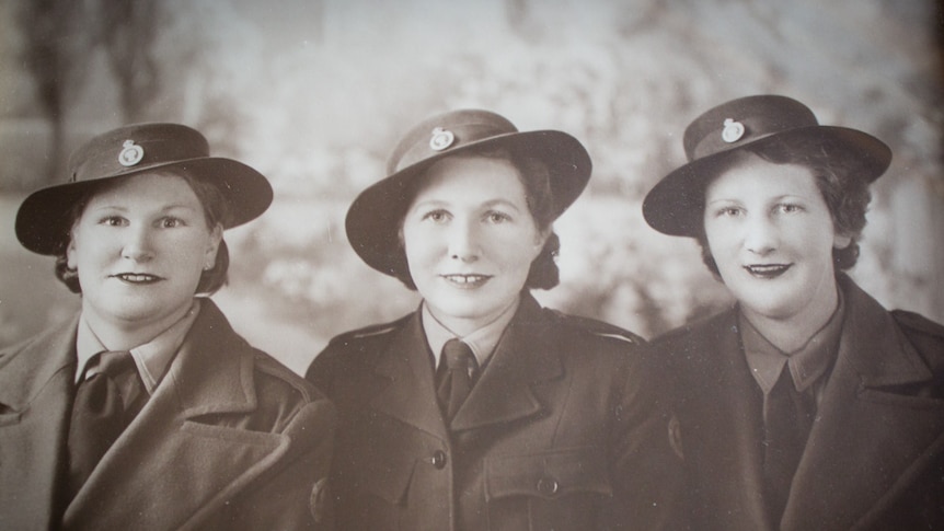June Chapple (nee Evans), right, with her sisters Enid and Eva in their Australian Women's Land Army uniforms.