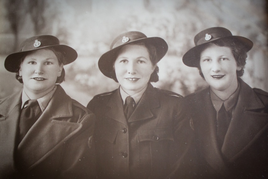 June Chapple (nee Evans), right, with her sisters Enid and Eva in their Australian Women's Land Army uniforms.