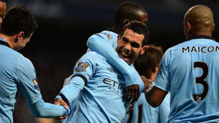Carlos Tevez (C) scored a double to help City to top of the English Premier League ladder.