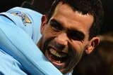 Carlos Tevez (C) scored a double to help City to top of the English Premier League ladder.