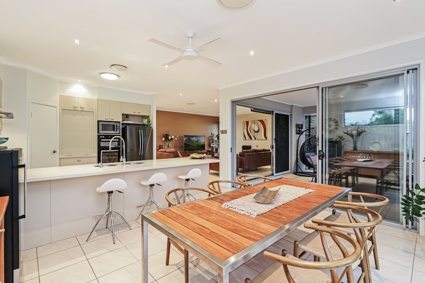 A dining table inside an open-plan kitchen area.