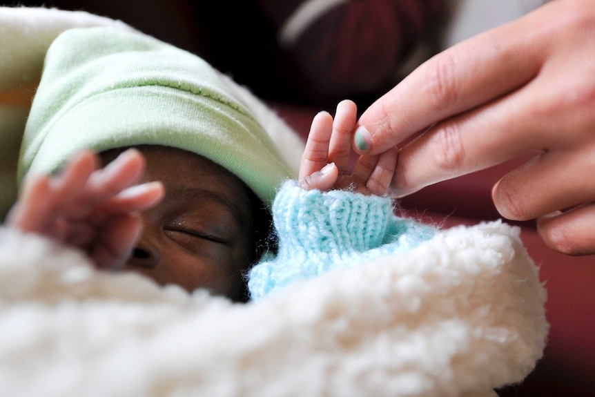 Baby sleeping in South African orphanage.