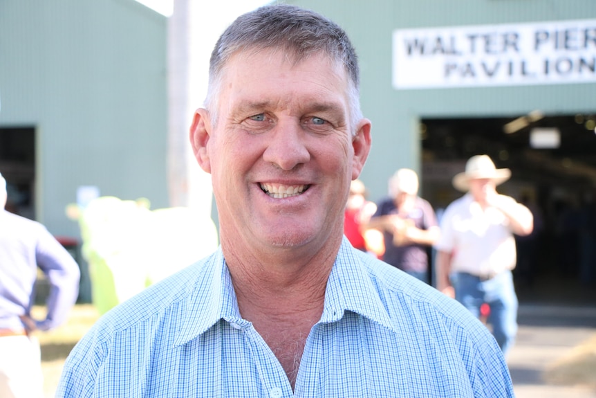 A man smiling at an agricultural show 