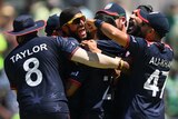 USA players embrace as they celebrate defeating Pakistan at the men's T20 World Cup.
