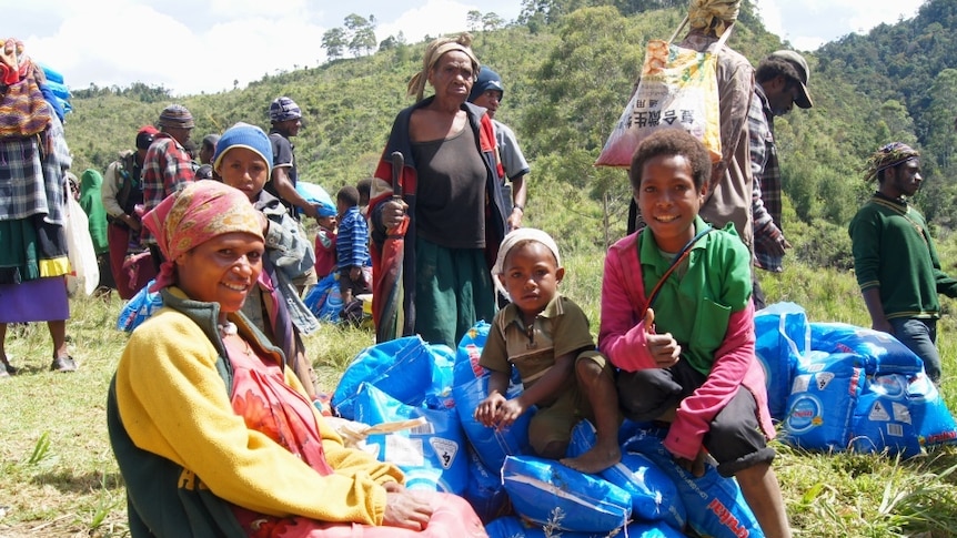 A family receives rice supplies in Enga Province