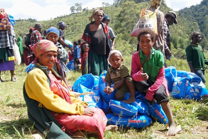 A family receives rice supplies in Enga Province