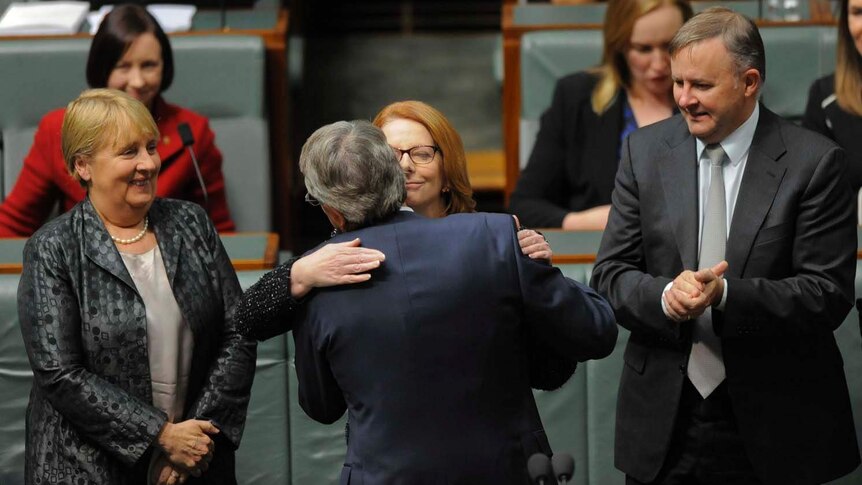 Prime Minister Julia Gillard hugs Treasurer Wayne Swan