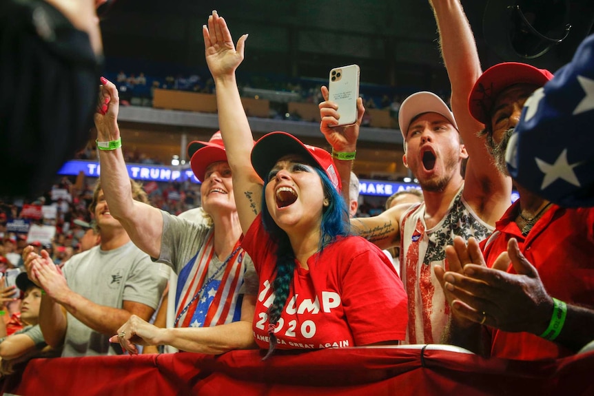 Attendees cheer while President Donald Trump speaks during his campaign rally in Tulsa.