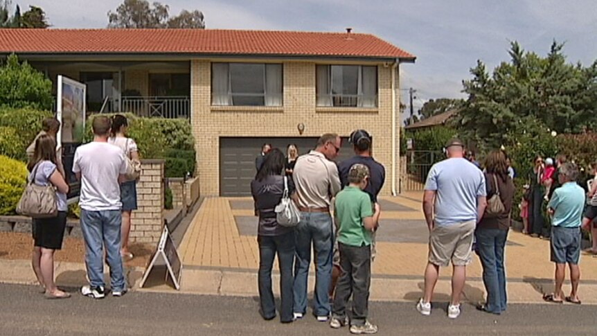 People attending a house auction in Canberra.