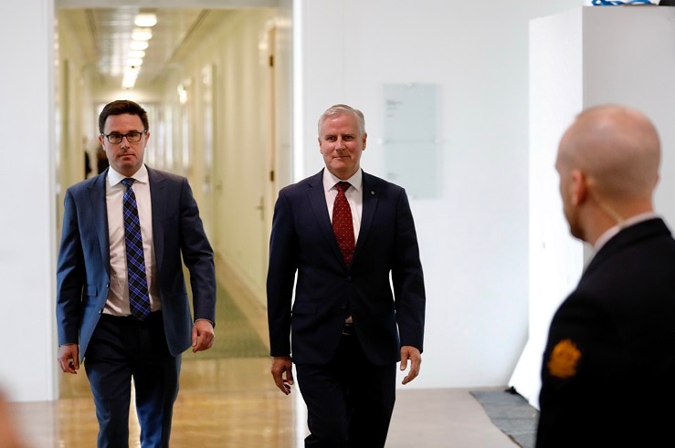 David Littleproud and Michael McCormack walk together down a hallway.