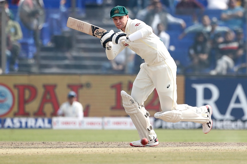 An Australian male batter plays to the leg side against India.