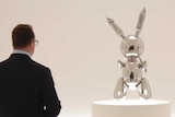People look at a sculpture entitled "Rabbit" by Jeff Koons during a preview at Christie's in New York.