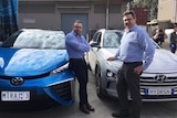 CSIRO researchers Michael Dolan (L) and David Harris with hydrogen-powered cars
