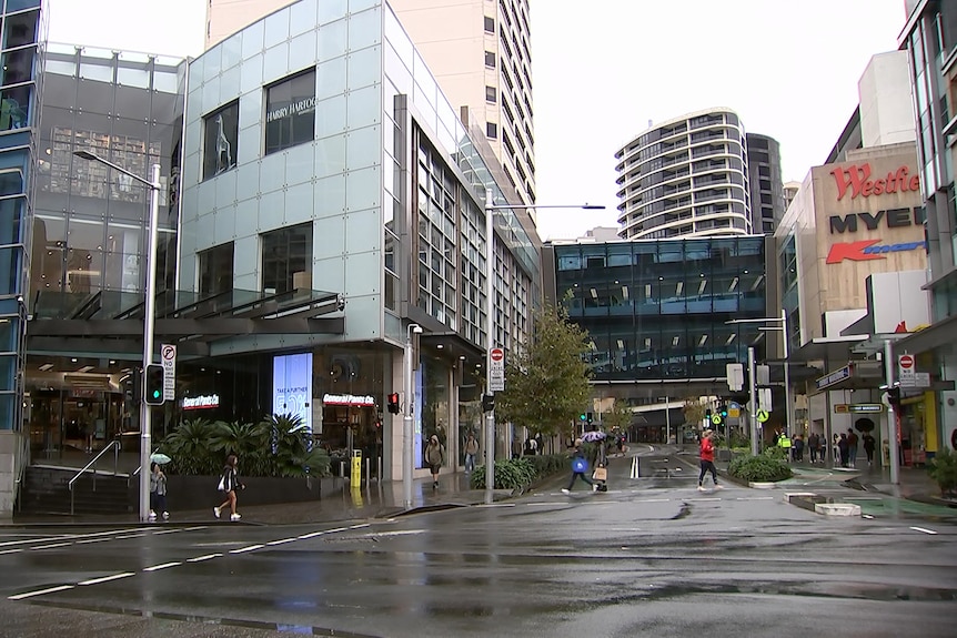 an outside view of westfield shopping centre at bondi junction on a cold wet sydney day