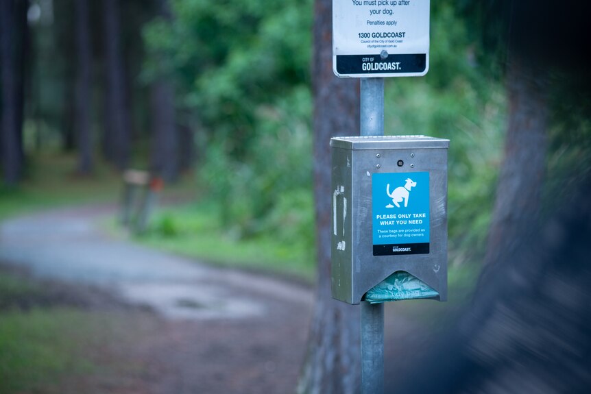 A dog waste bag dispenser at a Gold Coast dog park.