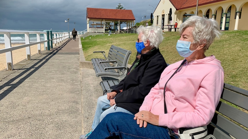 Two elderly women look out to sea at Nobby's beach.