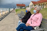 Two elderly women look out to sea at Nobby's beach.