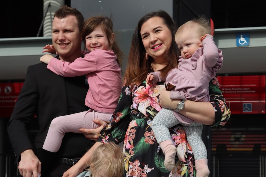 Jeff Horn and his wife holding two of their young daughters