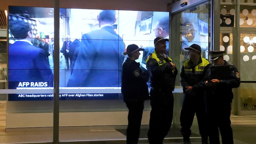 Police officers stand outside the ABC's Ultimo headquarters