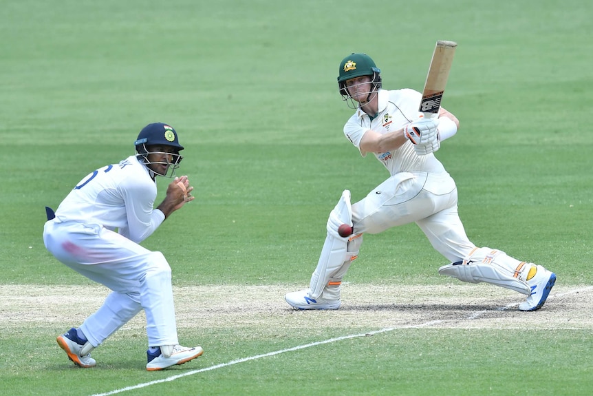 Australia batsman Steve Smith hits a cricket ball into Indian fielder Mayank Agarwal during a Test.
