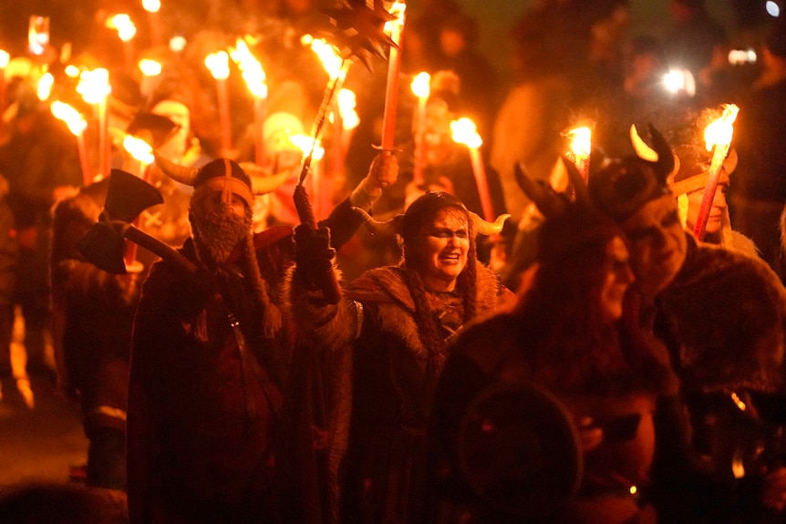Viking reenactors hold torches during the Flamborough Fire Festival.