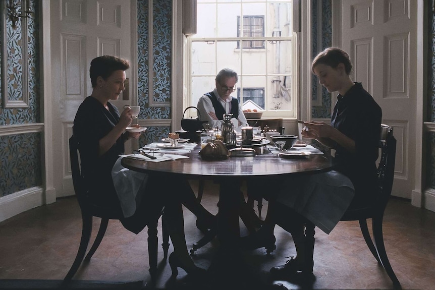 Cyril (Lesley Manville), Reynolds (Daniel Day-Lewis), and Alma (Vicky Krieps) at the table.