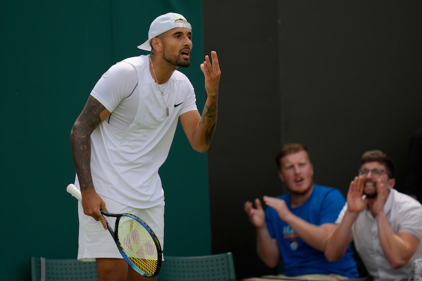 Nick Kyrgios holds his hand to his face as a fan claps behind him while another cups his hands to his face to boo