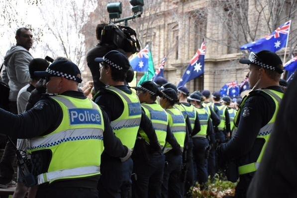 Police stand in a line in Bendigo at protests