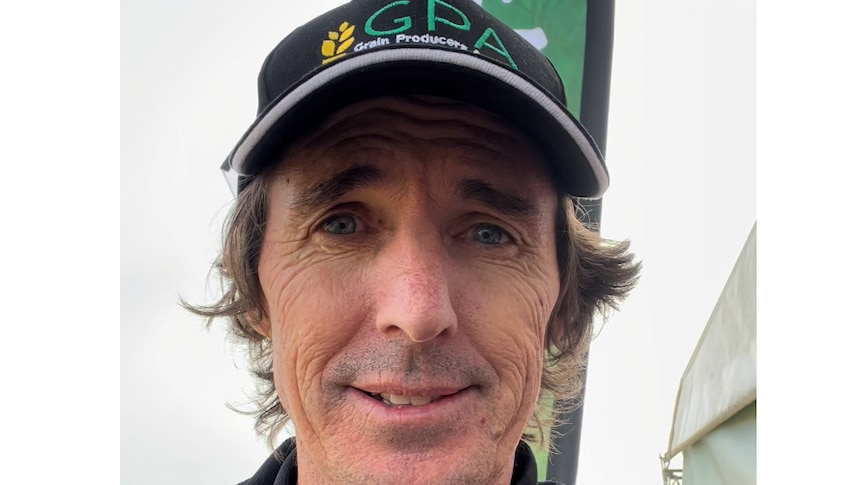 A close up portait of Brad Hogg, a middle aged man, wearing a black cap