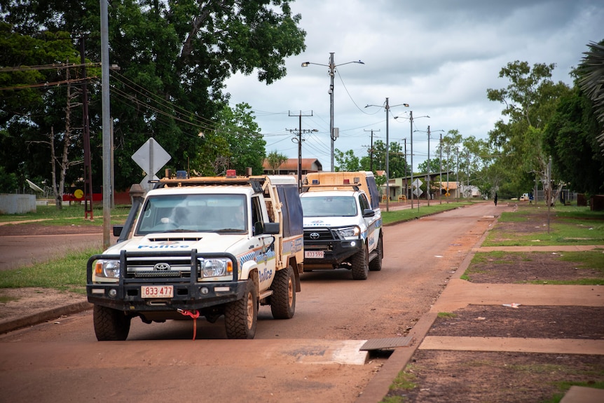 Two police cars in the community of Wadeye. 
