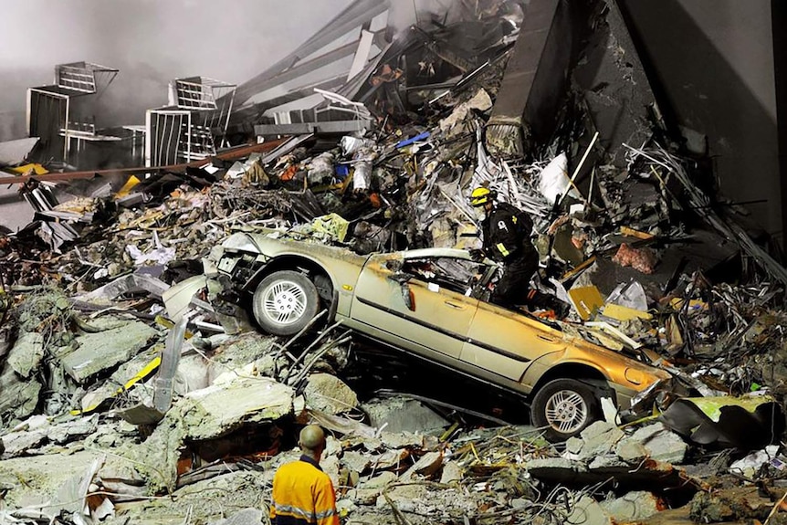 Rescue workers search through the collapsed CTV building after an earthquake in Christchurch.