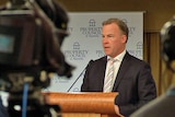 Tasmanian Premier Will Hodgman stands at a podium