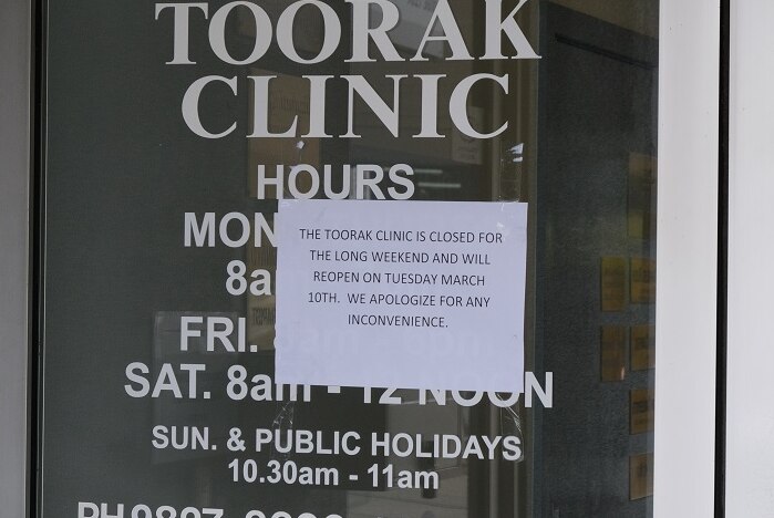 A sign printed on a sheet of paper on the door of The Toorak Clinic.