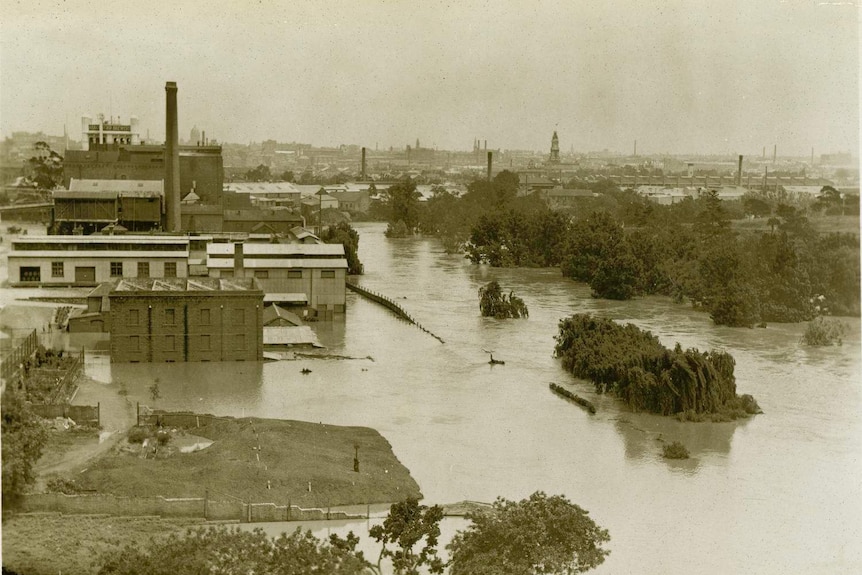 Black and white aerial photo of flooded factory.