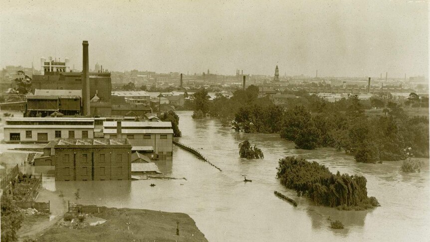 Black and white aerial photo of flooded factory.