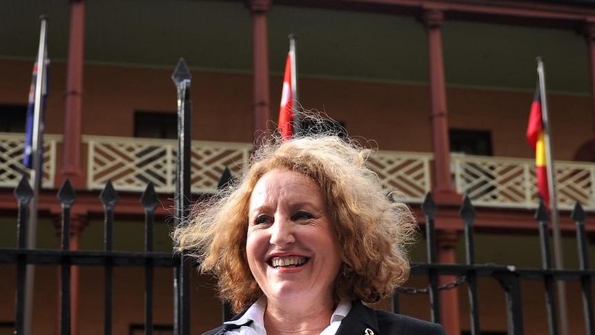 Gillian Sneddon walks past the New South Wales Parliament