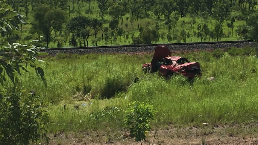 A damaged car near a railway line