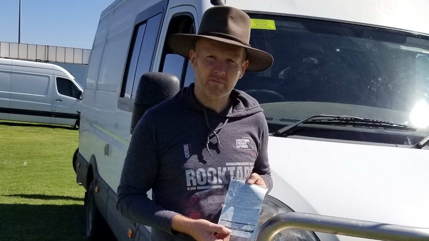 man standing next to a van