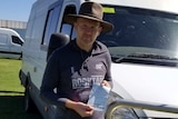 man standing next to a van