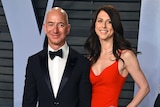 Jeff Bezos wearing a black suit and bow tie, MacKenzie Bezos wears a red evening gown.