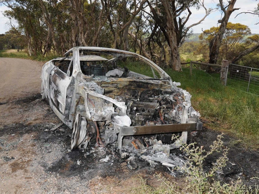 Burnt-out car linked with the man at the cliff base