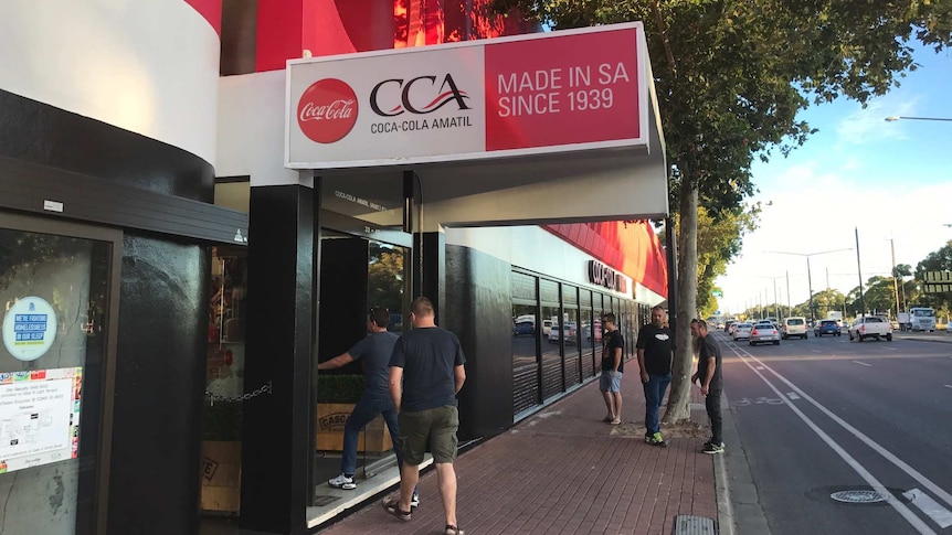 Coca-Cola workers arrive at the Adelaide factory ahead of a company announcement.