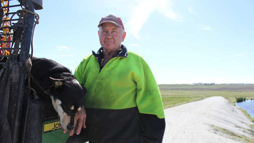 Mixed farmer Graham Barrett standing with his two working dog, Archie, at his Jerramungup farm