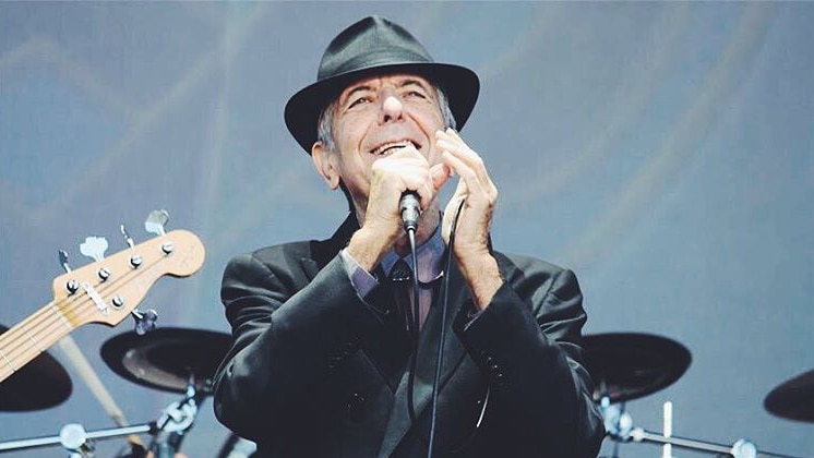 Leonard Cohen holding a microphone.
