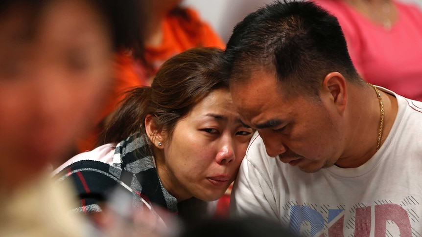 Relatives of AirAsia QZ8501 passengers wait for news