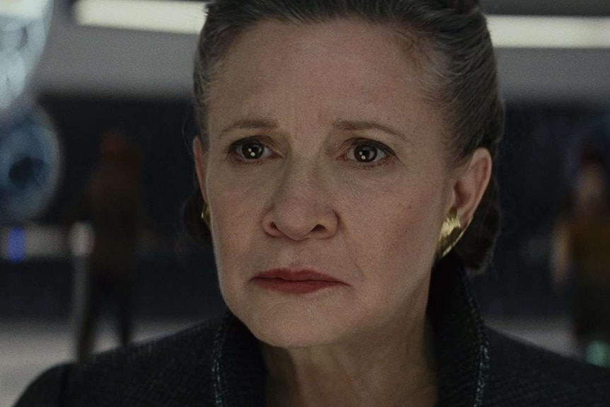 A close of of Carrie Fisher in Star Wars The Last Jedi, looking serious.