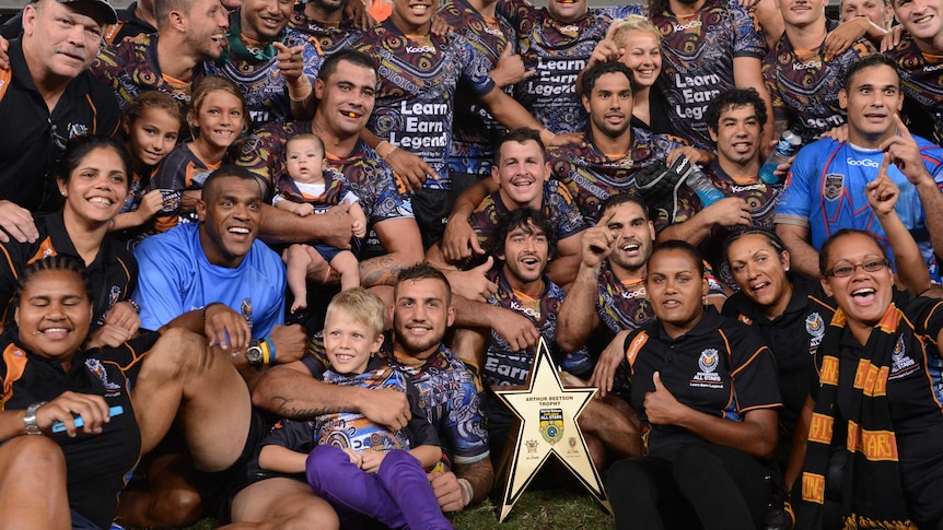 The Indigenous All Stars celebrate after beating the NRL All Stars at Lang Park in February 2013.