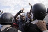 Protester argues with National Police officers at a police cordon during a demonstration by opposition groups in Port-au-Prince.