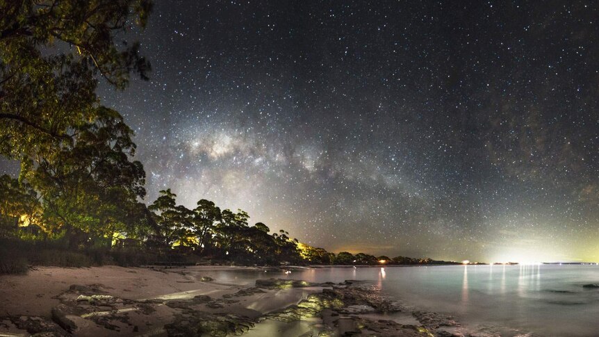 Dawn and starry night over quiet beach