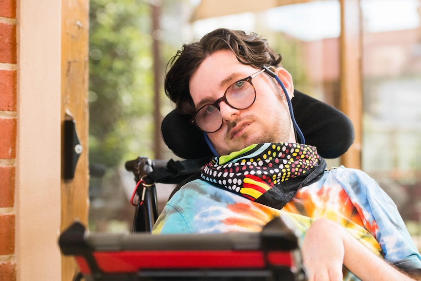 Jacob Hughes sits in a wheelchair and looks into the camera.